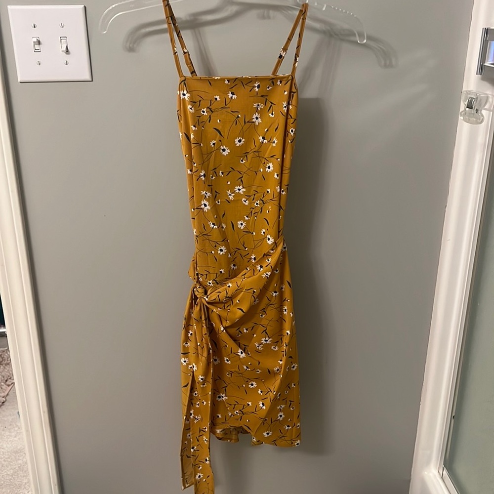 Spaghetti strap yellow dress with blue and white flowers.